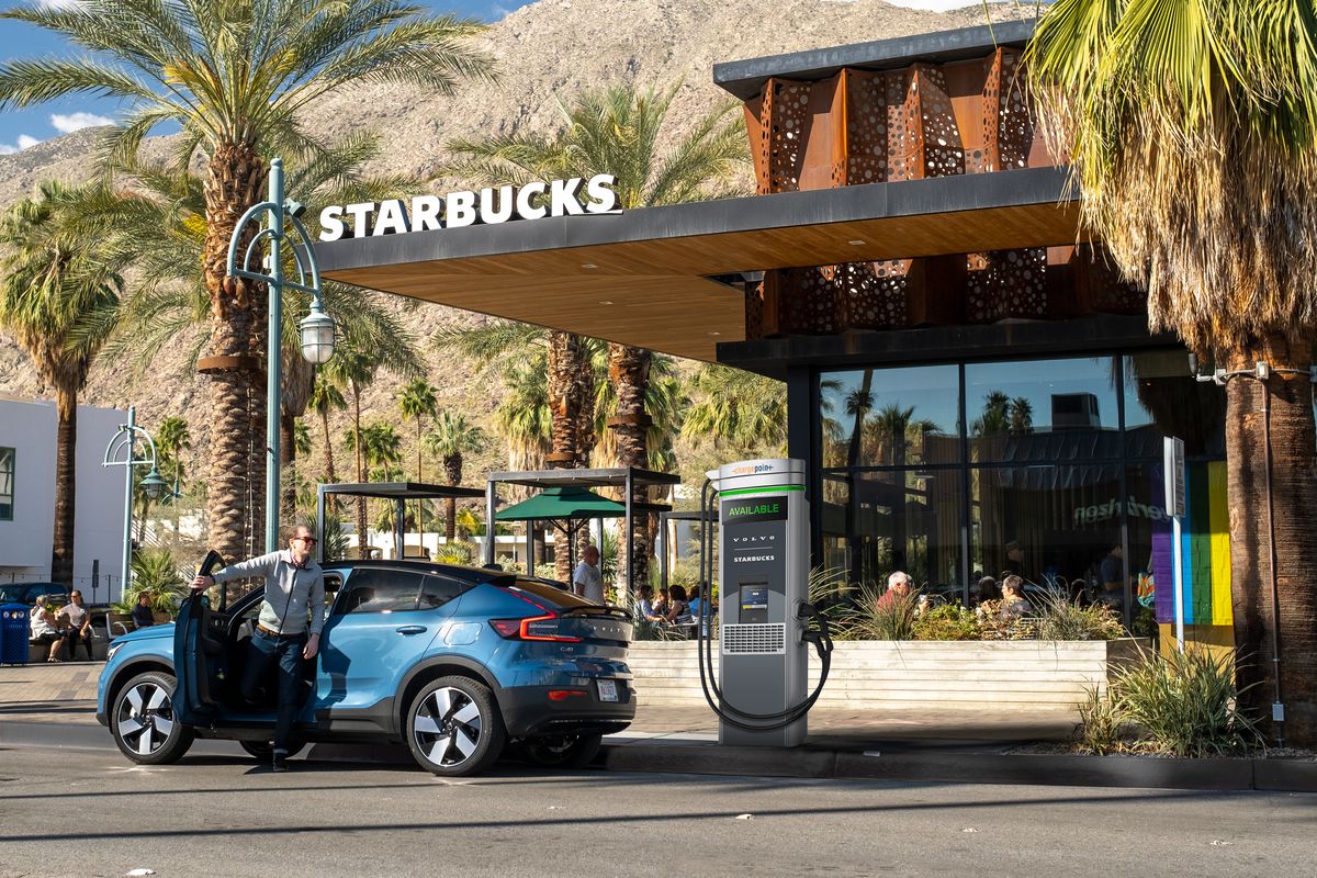 car parked in front of starbucks plugged into ev charger